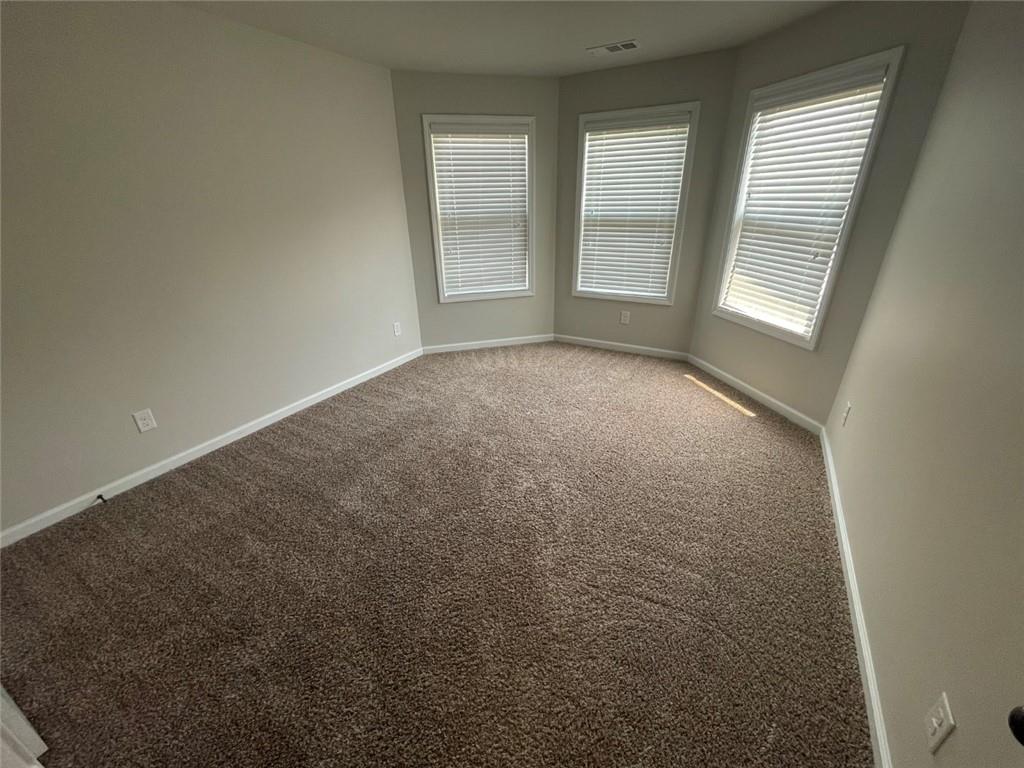 4810 Haysboro Way Cumming, GA 30040 - Photo 24 of 48 an empty room with windows