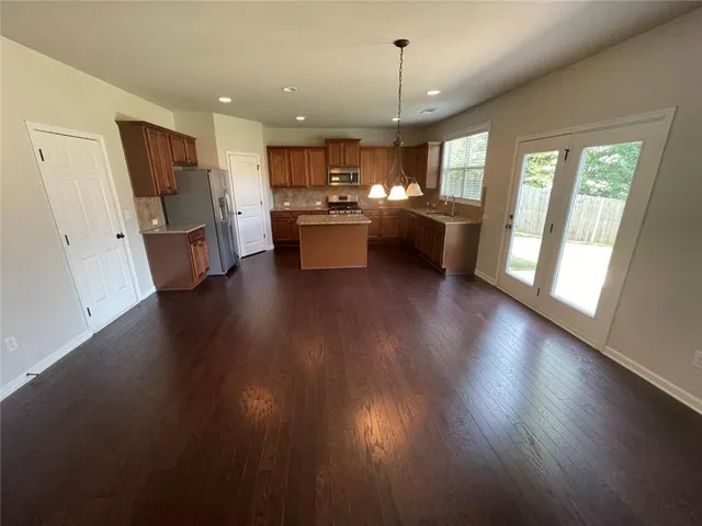 a view of a kitchen with stove and wooden floor