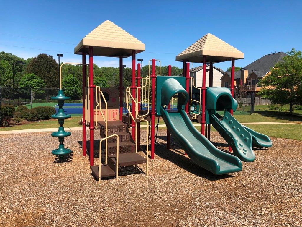 4810 Haysboro Way Cumming, GA 30040 - Photo 41 of 48 an outdoor space with lots of swings and slides