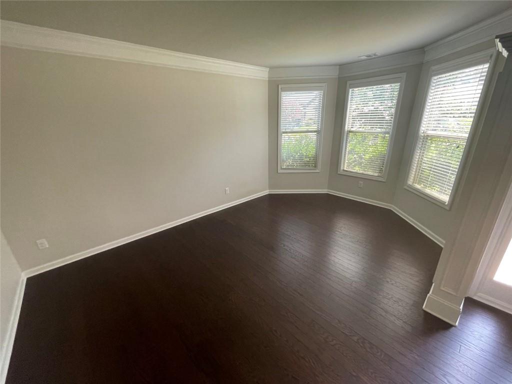 4810 Haysboro Way Cumming, GA 30040 - Photo 9 of 48 an empty room with wooden floor and windows