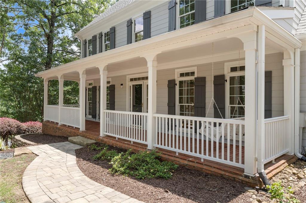 8965 Laurel Way Alpharetta, GA 30022 - Photo 3 of 79 a view of a house with a small yard and wooden floor and fence