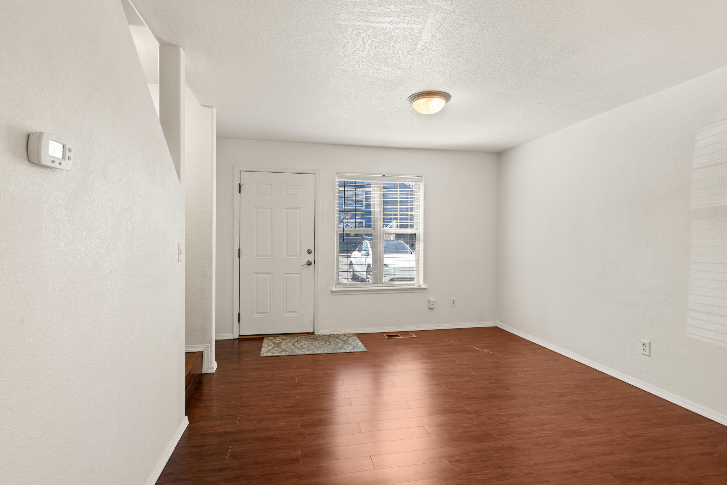 450 Midway Road, Unit 33 Medford, OR 97501 - Photo 6 of 21 an empty room with wooden floor and windows