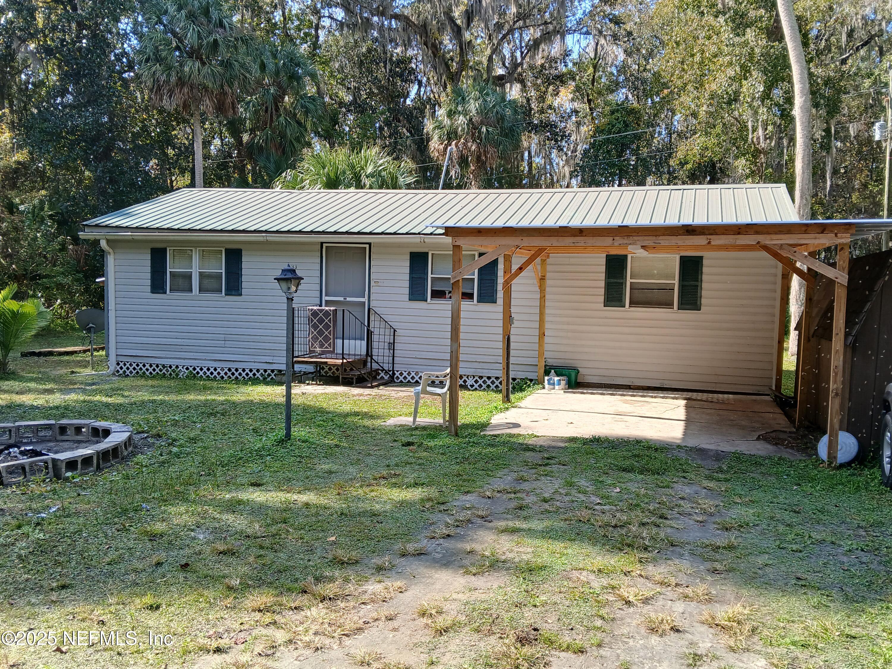a backyard of a house with barbeque oven
