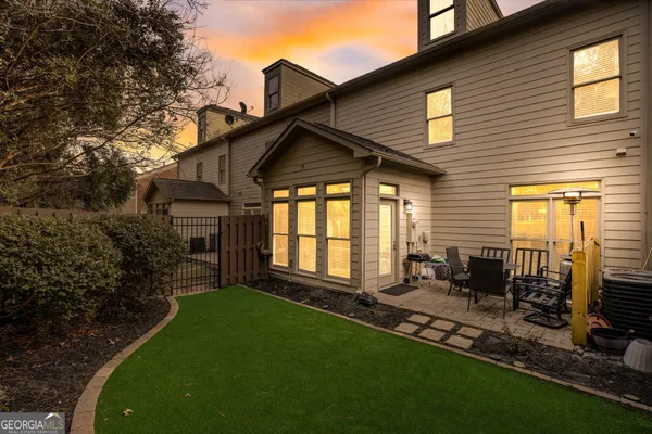 a backyard of a house with yard and outdoor seating