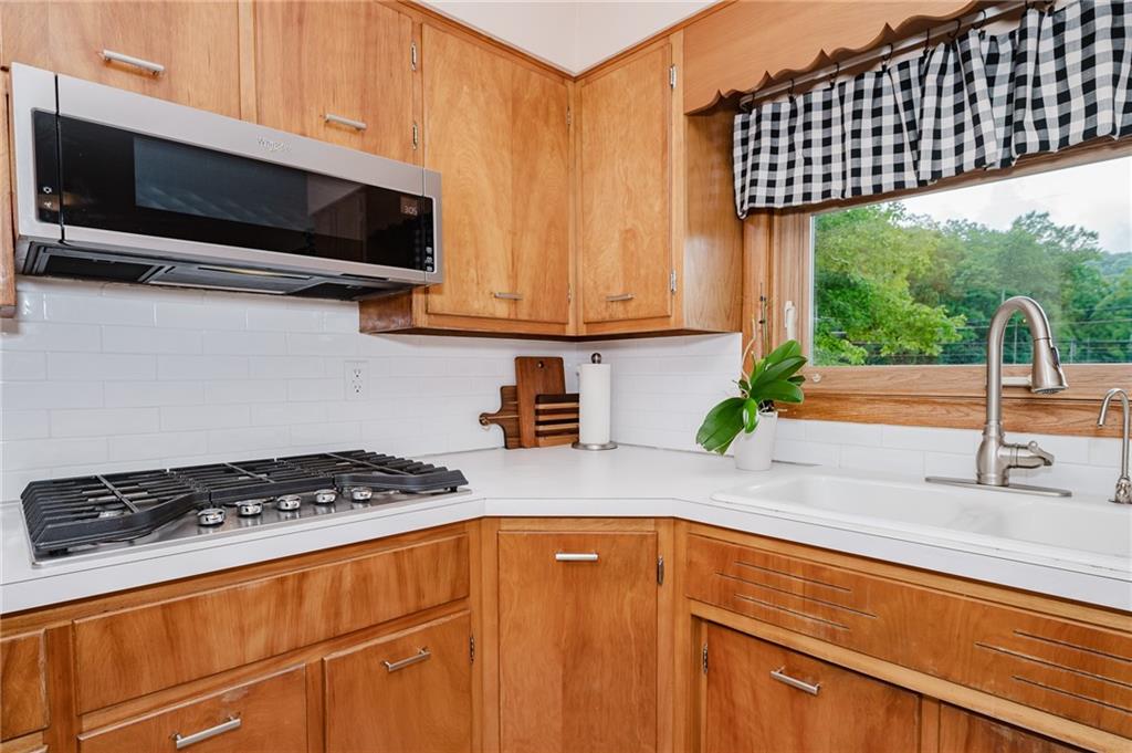 555 North 9th Street Indiana, PA 15701 - Photo 12 of 38 a kitchen with stainless steel appliances a stove a sink and a microwave