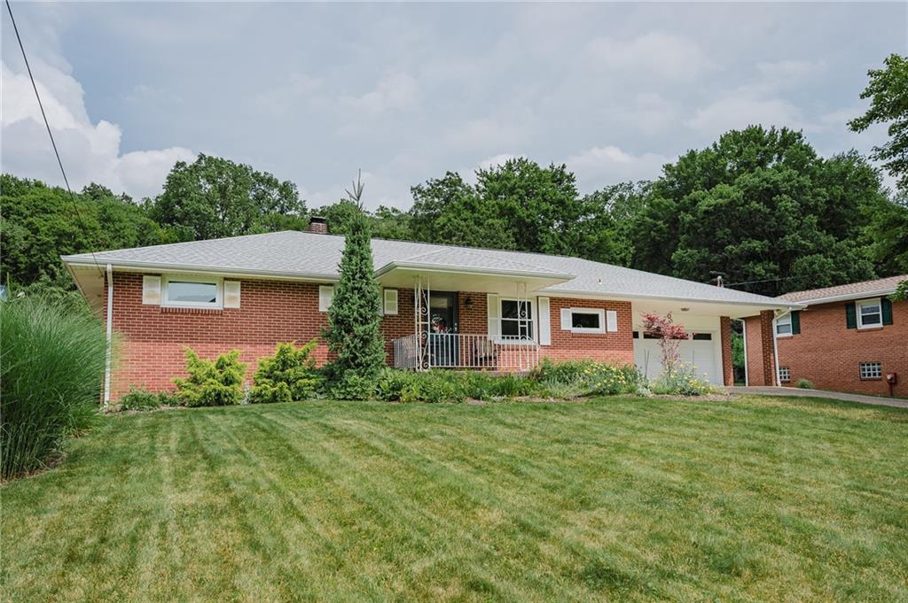 555 North 9th Street Indiana, PA 15701 - Photo 3 of 38 a view of a yard in front of a house with plants and large tree
