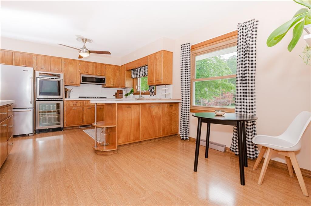 555 North 9th Street Indiana, PA 15701 - Photo 7 of 38 a kitchen with stainless steel appliances wooden floor and chair