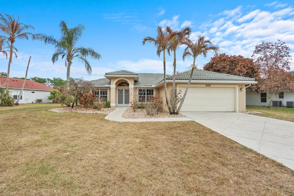 a view of a house with a yard and garage