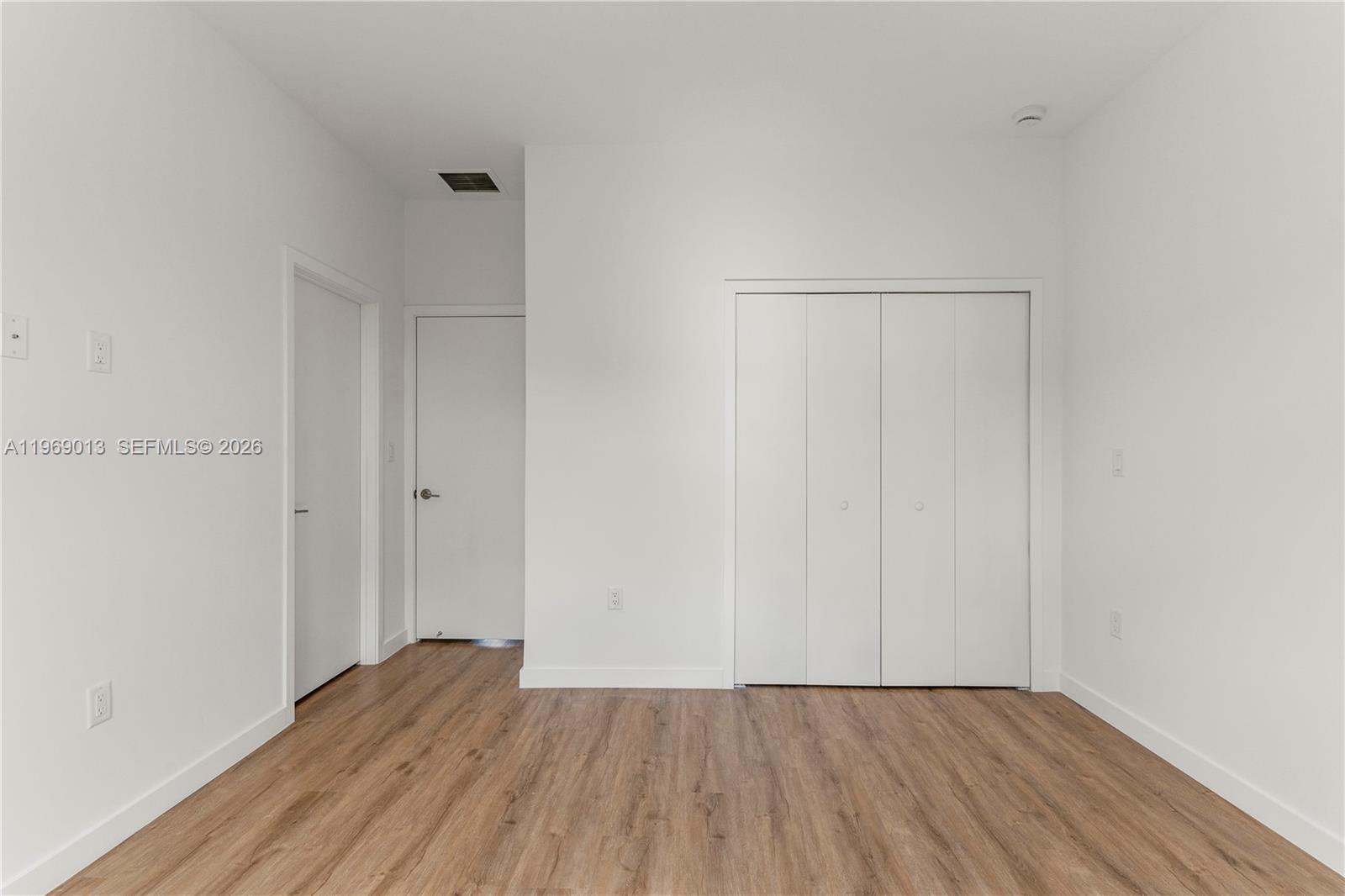 400 Southwest 1st Street, Unit 1 Florida City, FL 33034 - Photo 13 of 28 a view of an empty room with wooden floor