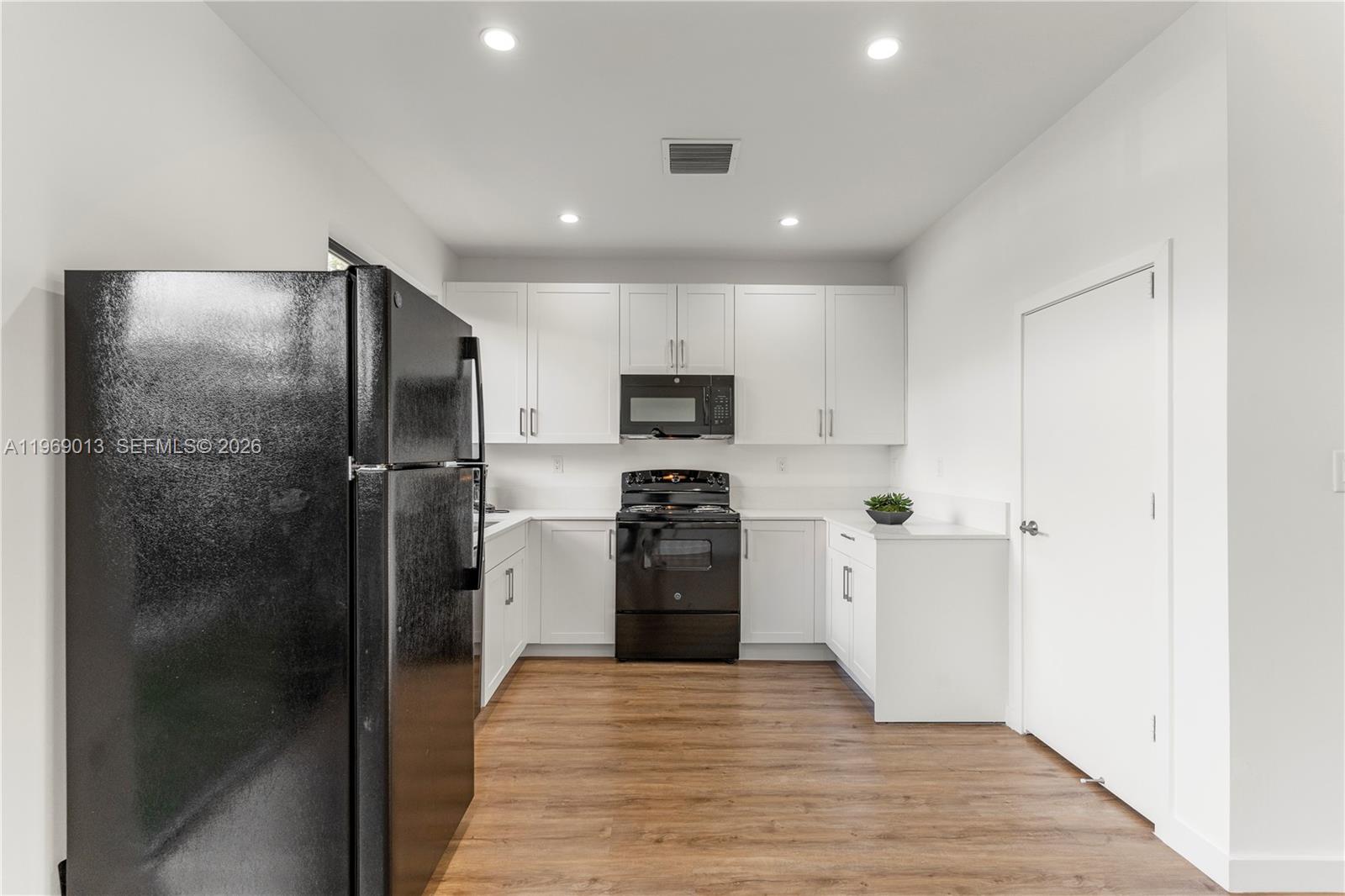 400 Southwest 1st Street, Unit 1 Florida City, FL 33034 - Photo 7 of 28 a kitchen with a refrigerator and a sink