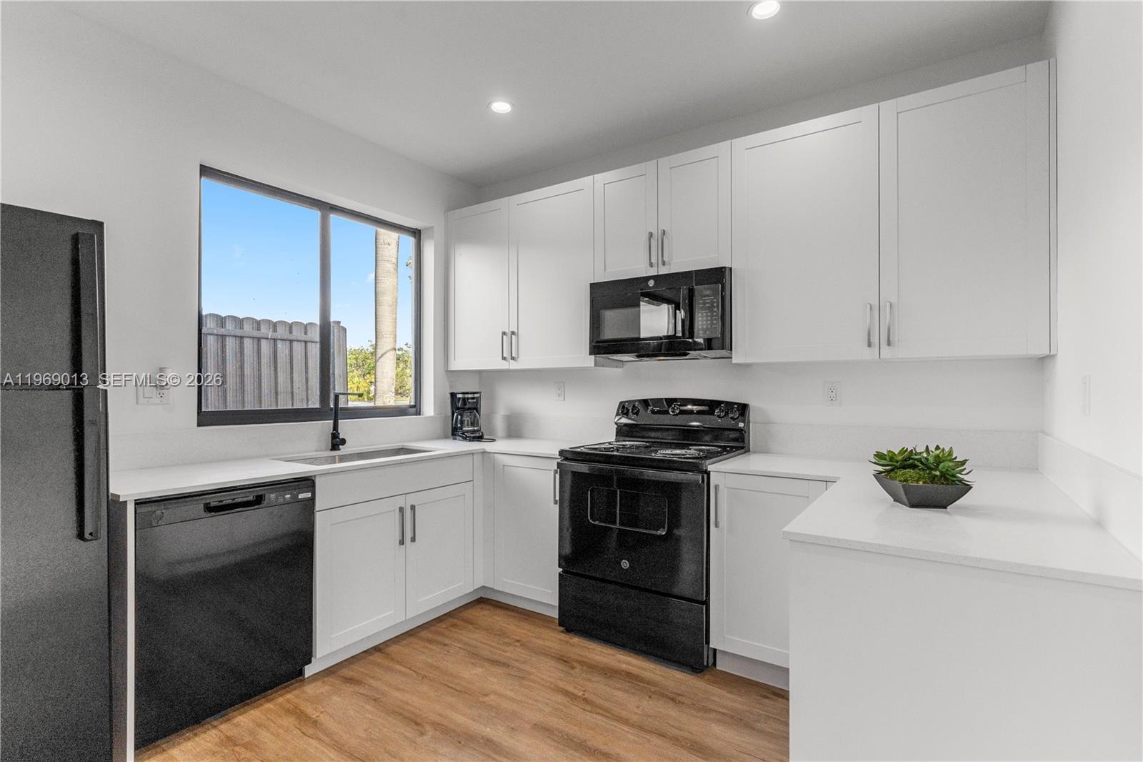 400 Southwest 1st Street, Unit 1 Florida City, FL 33034 - Photo 8 of 28 a kitchen with stainless steel appliances granite countertop a stove a sink and a refrigerator