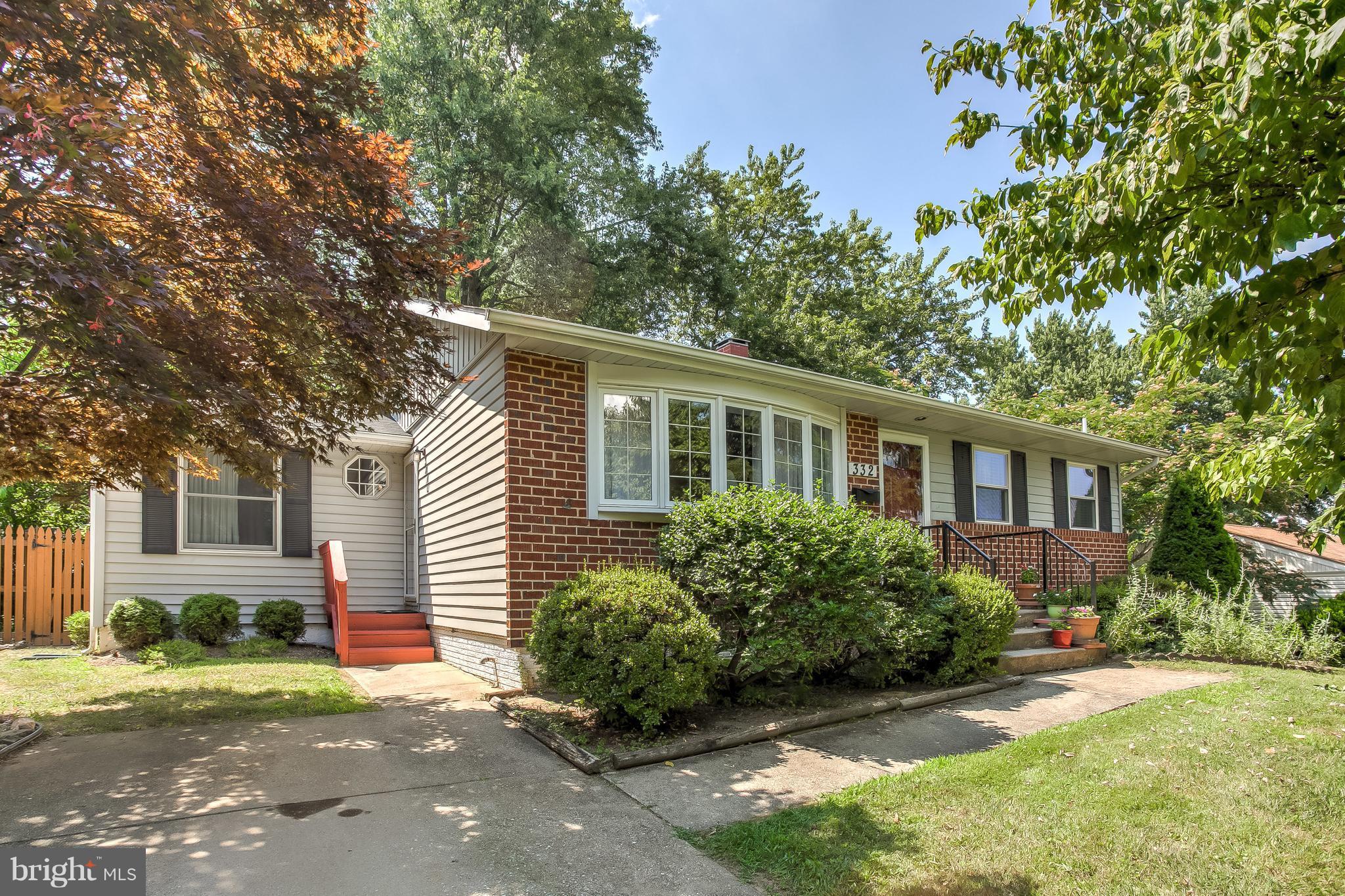 a front view of a house with a yard and potted plants