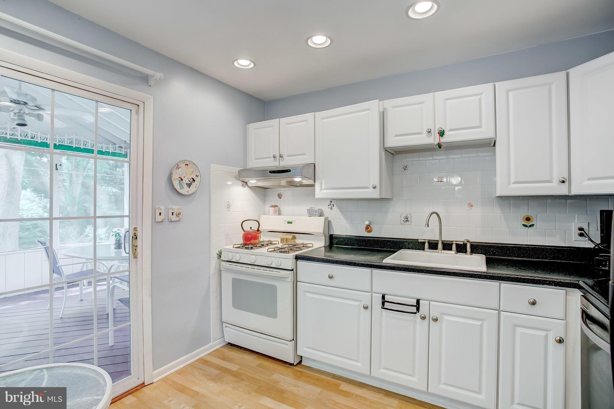 332 Timber Grove Road Reisterstown, MD 21136 - Photo 7 of 23 a kitchen with granite countertop white cabinets and white appliances