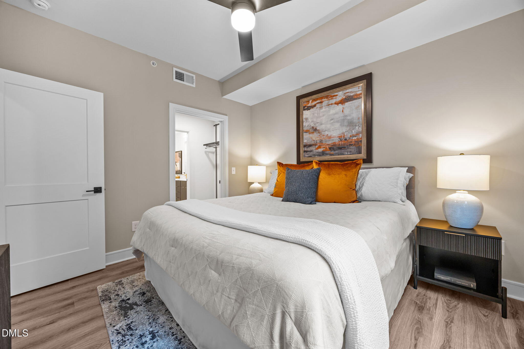 615 West Peace Street, Unit 308 Raleigh, NC 27605 - Photo 13 of 25 a bedroom with a bed and wooden floor