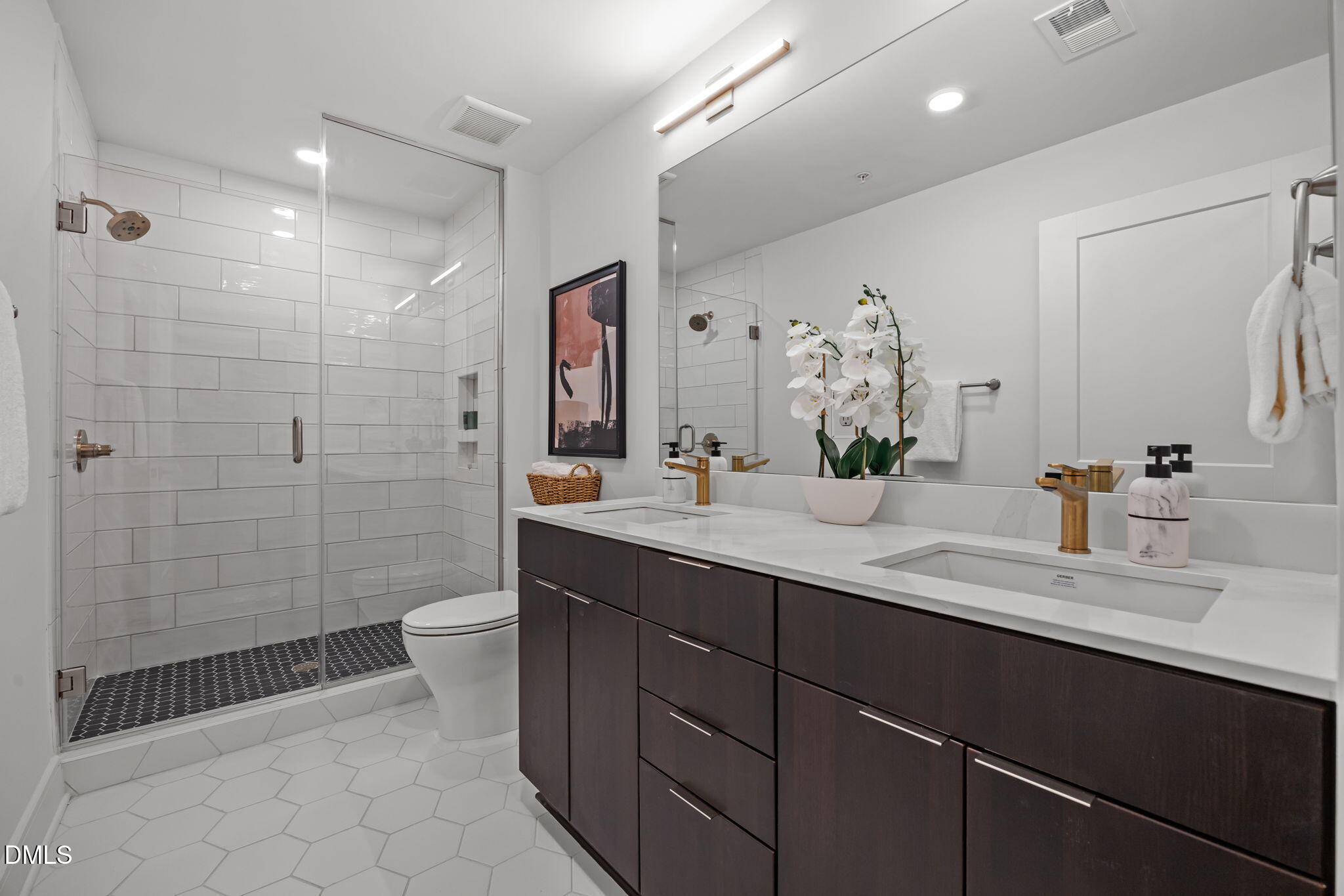 615 West Peace Street, Unit 308 Raleigh, NC 27605 - Photo 14 of 25 a bathroom with a double vanity sink toilet and shower