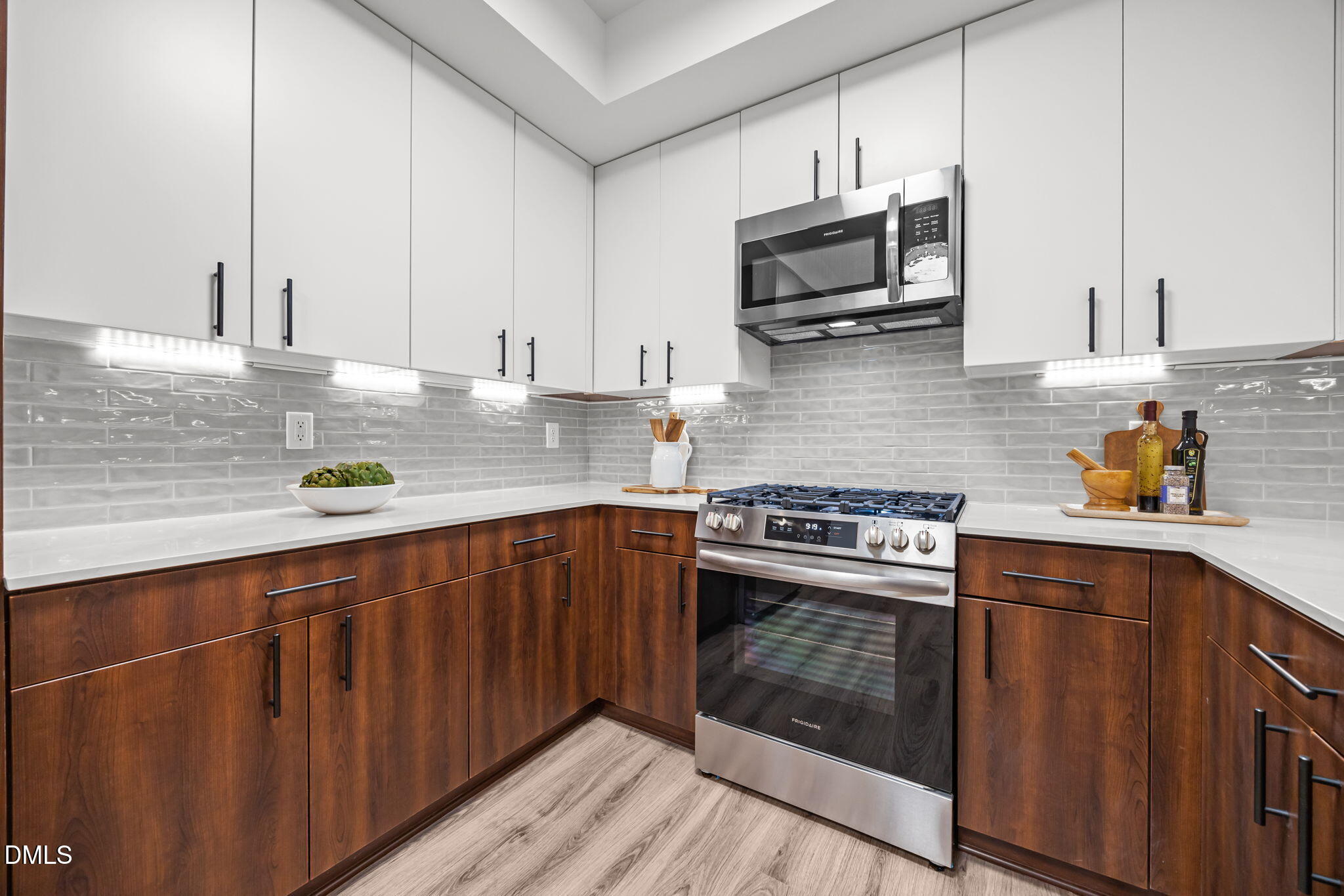 615 West Peace Street, Unit 308 Raleigh, NC 27605 - Photo 4 of 25 a kitchen with stainless steel appliances granite countertop a stove a sink and a microwave