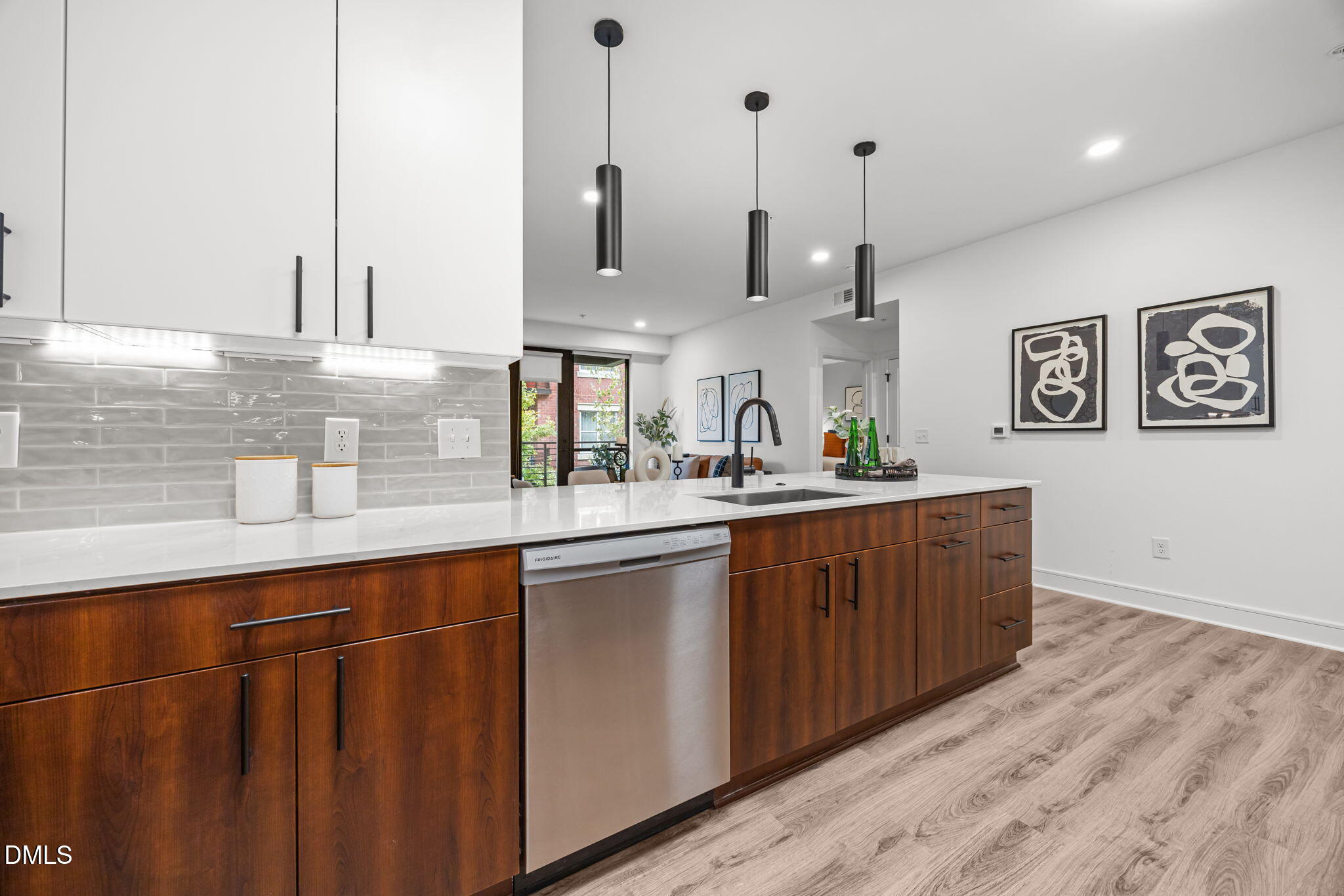 615 West Peace Street, Unit 308 Raleigh, NC 27605 - Photo 5 of 25 a kitchen with stainless steel appliances granite countertop a sink a island and a wooden cabinets