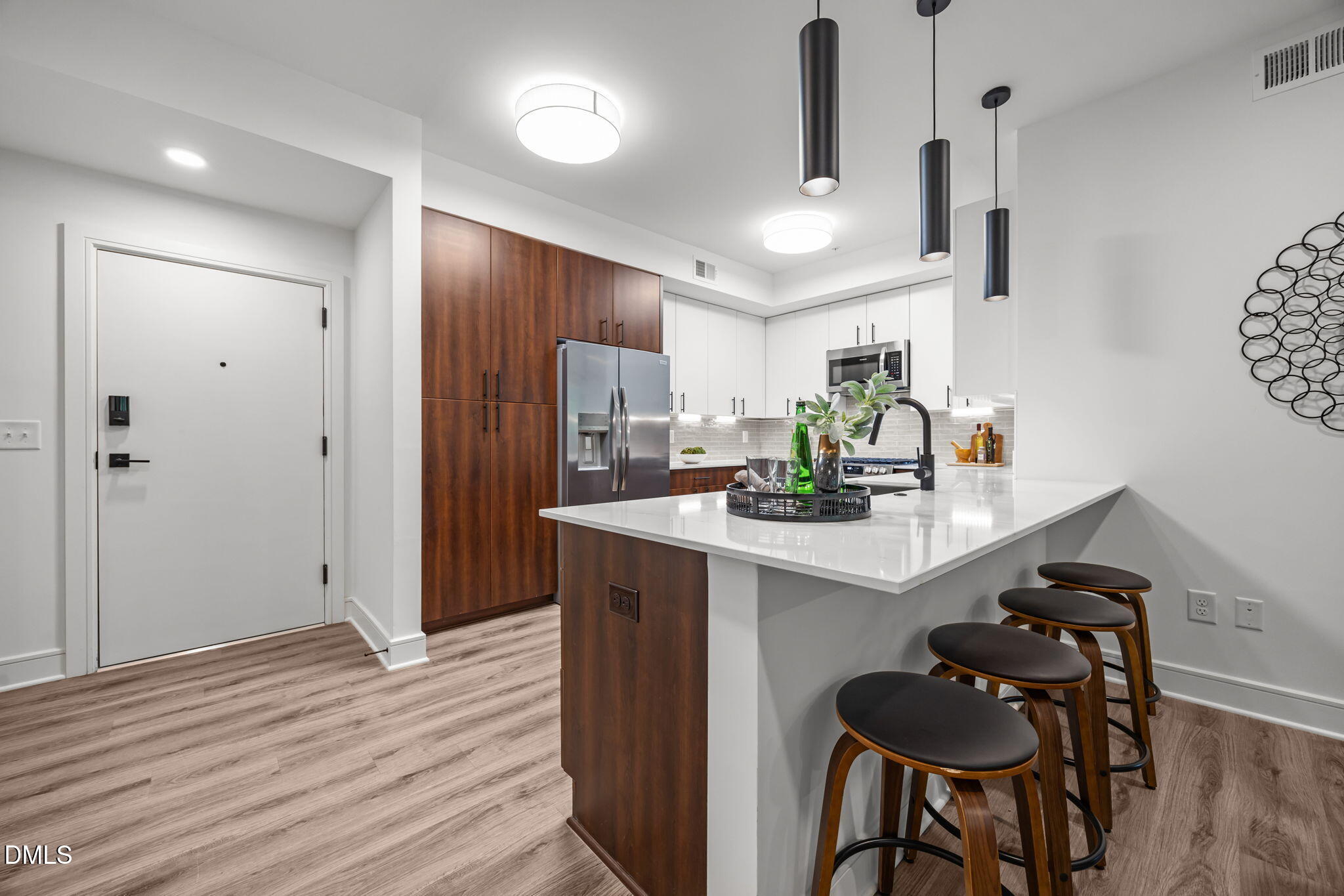 615 West Peace Street, Unit 308 Raleigh, NC 27605 - Photo 6 of 25 a kitchen with stainless steel appliances kitchen island granite countertop a refrigerator and a stove top oven