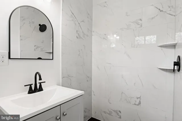 a bathroom with a sink and mirror