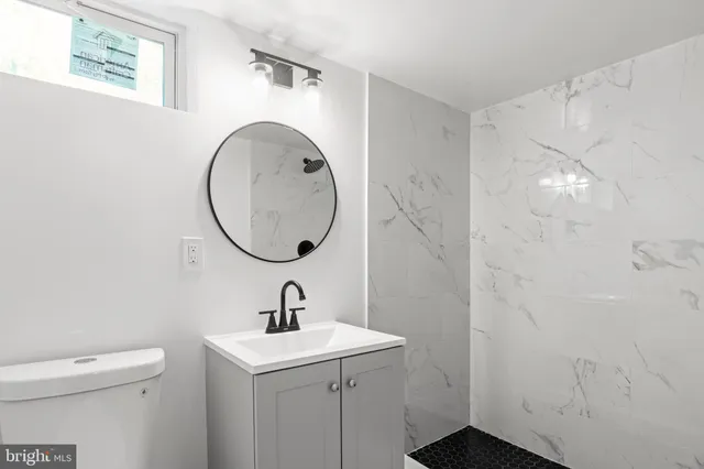 a bathroom with a sink a mirror and a shower