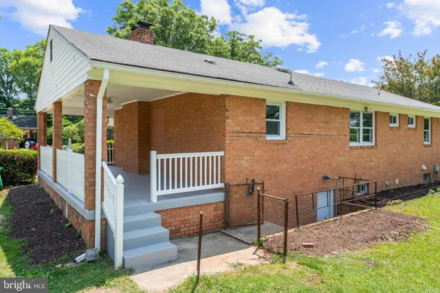 a view of a backyard with wooden fence