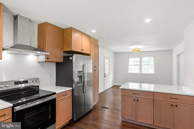 a kitchen with wooden cabinets and a stove top oven