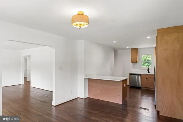 a view of kitchen and hall with wooden floor