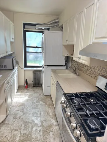 a kitchen with a stove and a sink
