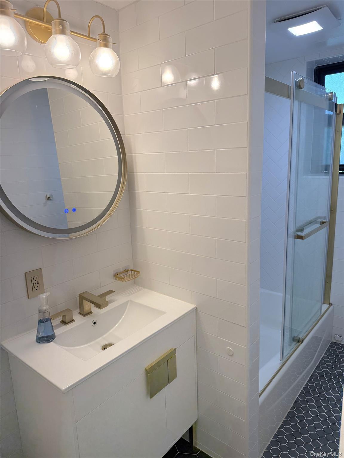 22-27 76th Street, Unit B2 Queens, NY 11370 - Photo 8 of 12 a bathroom with a sink and a mirror