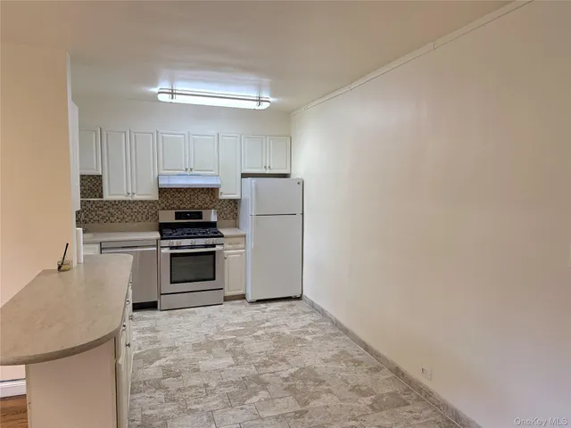 a kitchen with a refrigerator sink and stove top oven