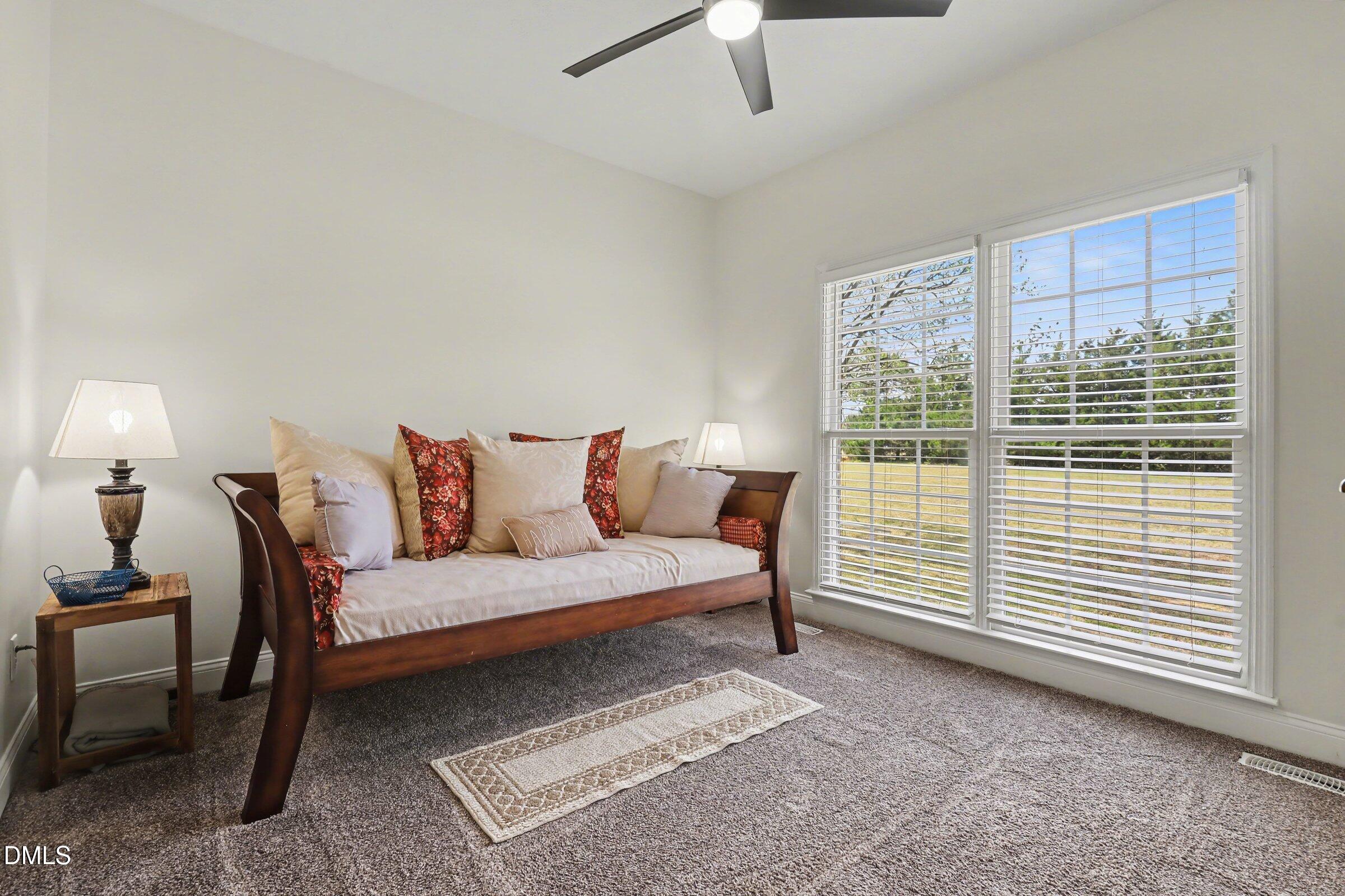 430 Fred Hall Road Stedman, NC 28391 - Photo 45 of 63 a spacious bedroom with a bed a table and chair