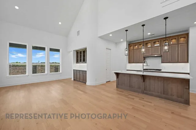 a large kitchen with kitchen island a sink stainless steel appliances and cabinets