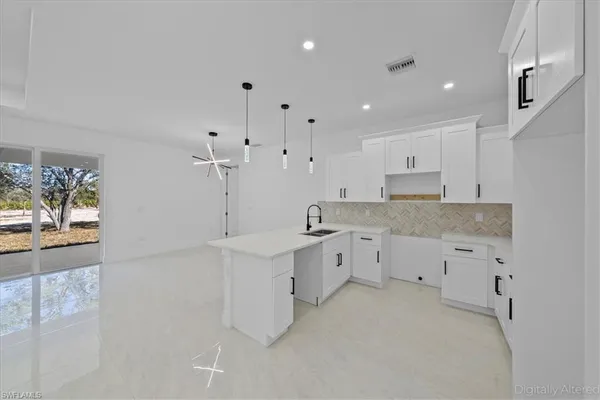 a kitchen with a sink and cabinets