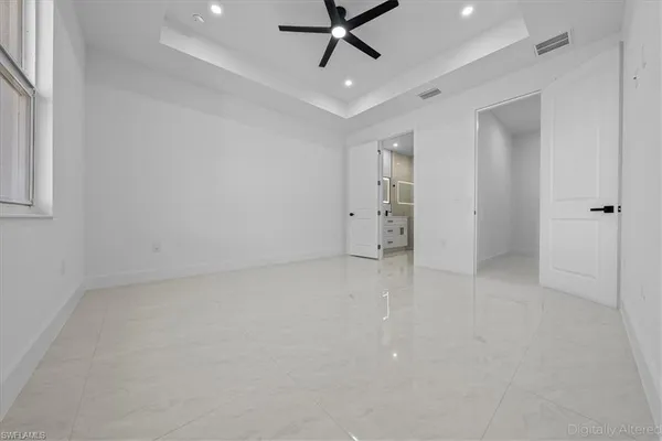 an empty room with closet and windows