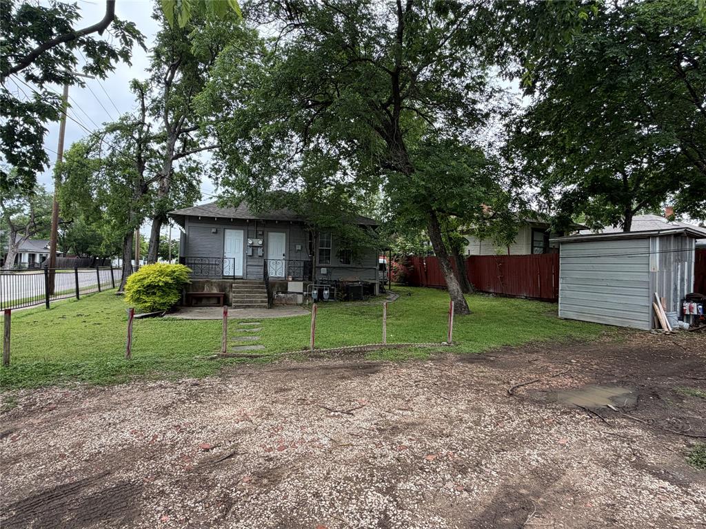 801 Wayne Street Dallas, TX 75223 - Photo 15 of 15 a view of a house with backyard and a tree