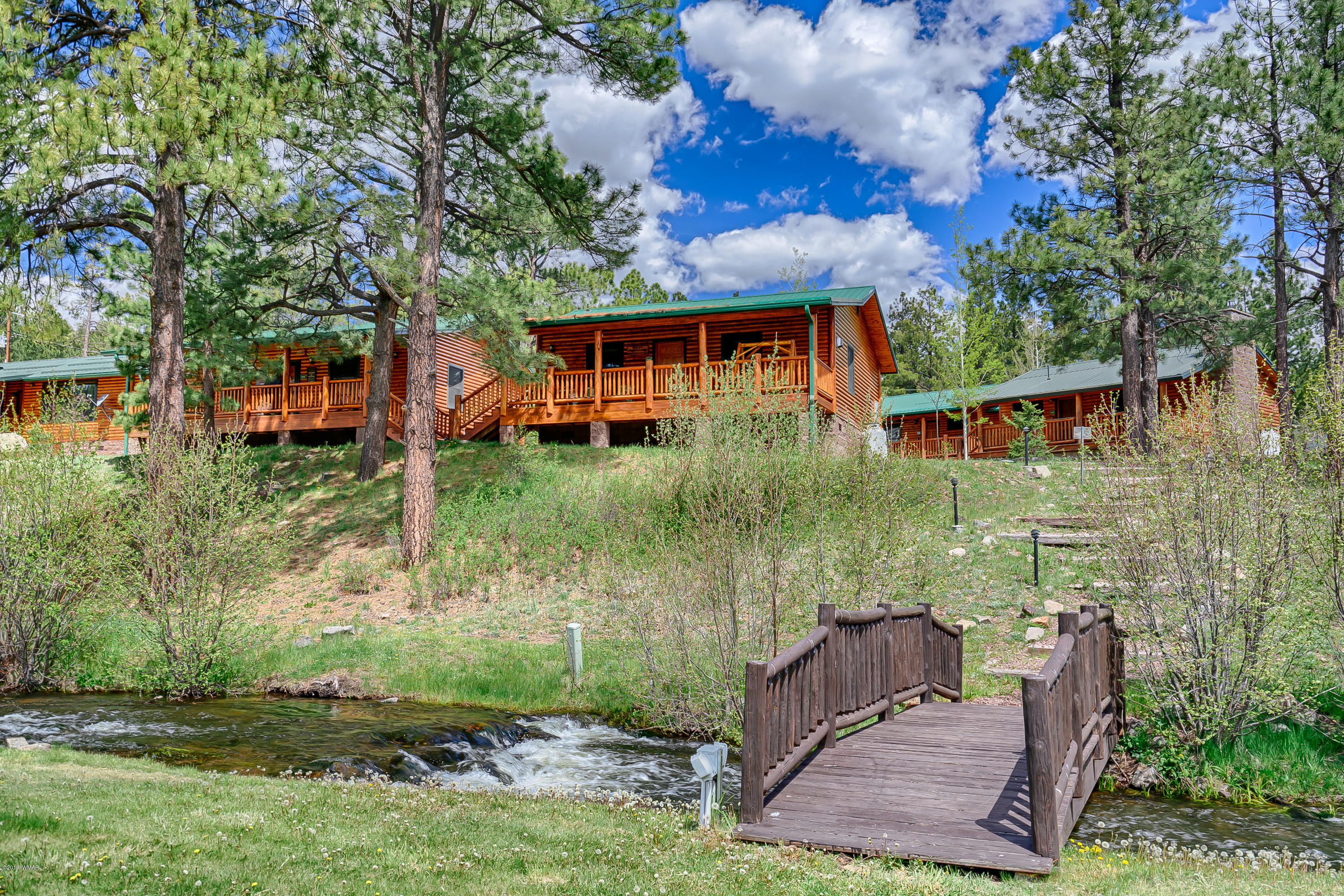 1120 Main, Unit 108 Greer, AZ 85927 - Photo 1 of 35 a front view of a house with garden