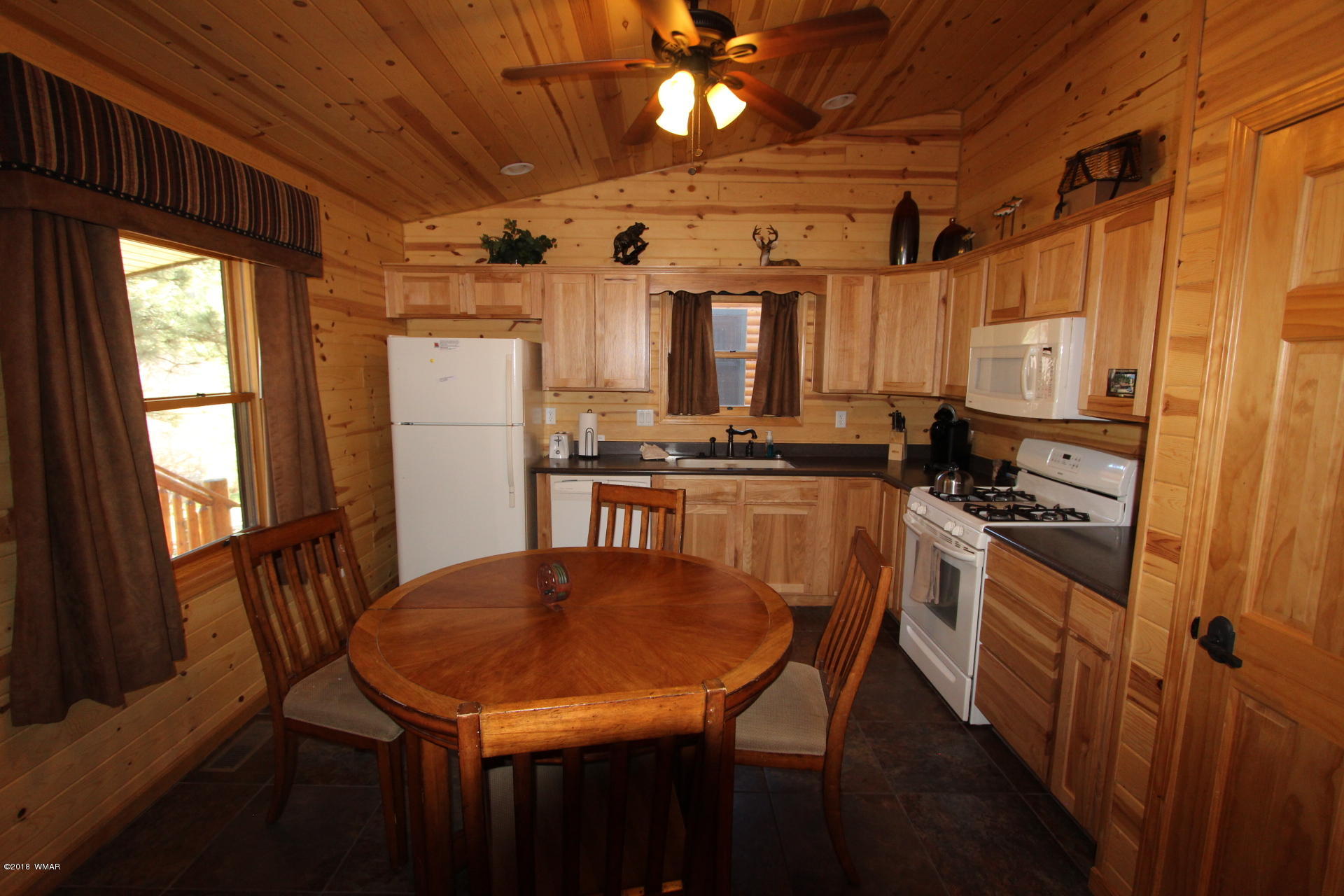 1120 Main, Unit 108 Greer, AZ 85927 - Photo 26 of 35 a kitchen with stainless steel appliances a dining table chairs stove refrigerator and sink