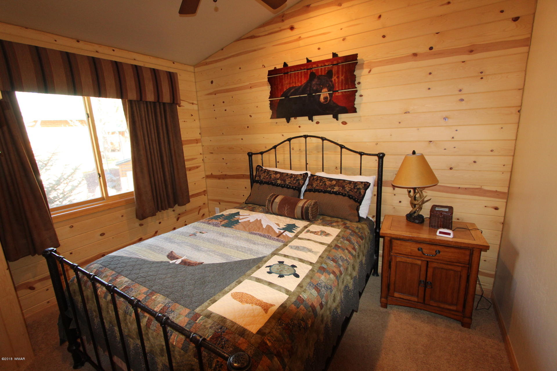 1120 Main, Unit 108 Greer, AZ 85927 - Photo 27 of 35 a bedroom with a bed a dresser and window