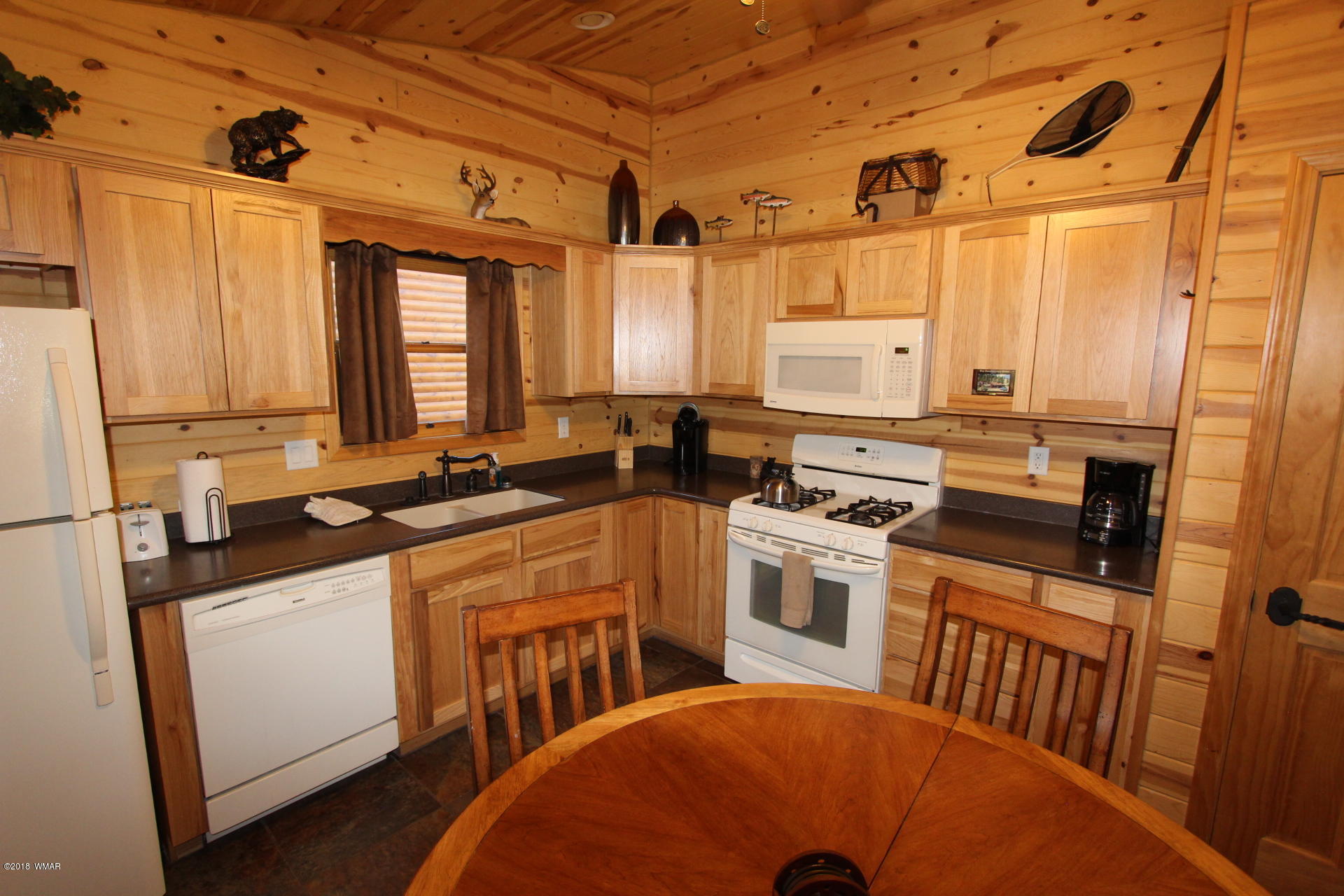 1120 Main, Unit 108 Greer, AZ 85927 - Photo 32 of 35 a kitchen with stainless steel appliances a stove a sink a refrigerator white cabinets and wooden floor