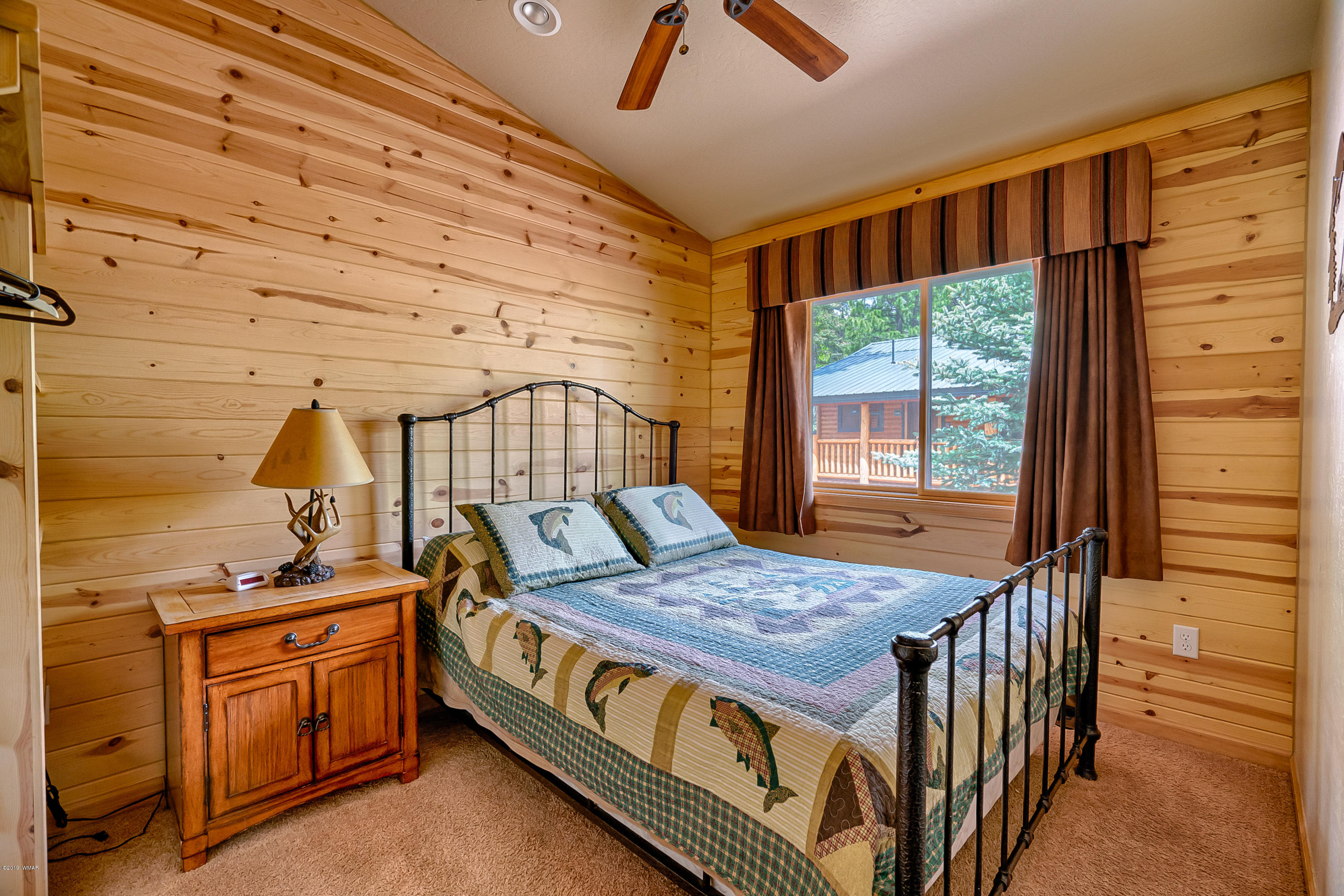 1120 Main, Unit 108 Greer, AZ 85927 - Photo 7 of 35 a bedroom with a bed and a table