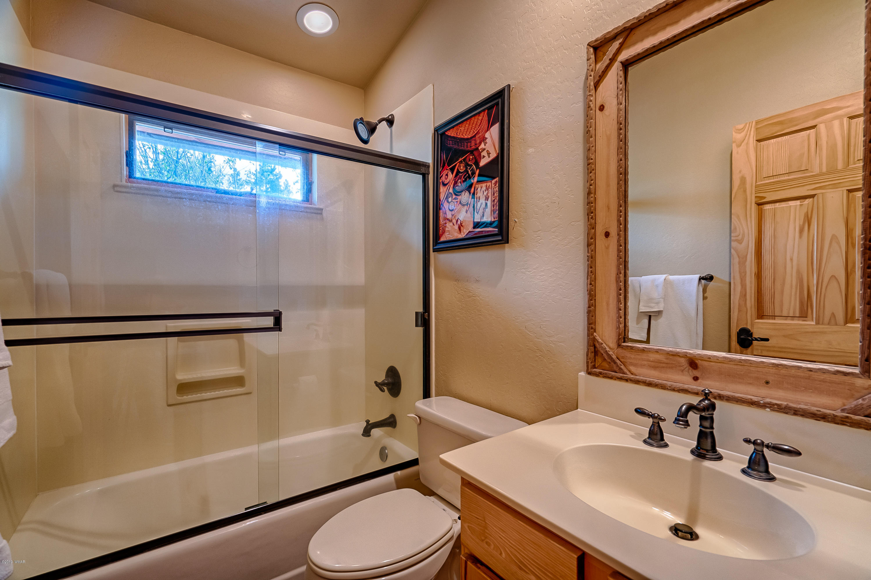 1120 Main, Unit 108 Greer, AZ 85927 - Photo 8 of 35 a bathroom with a sink a toilet and shower