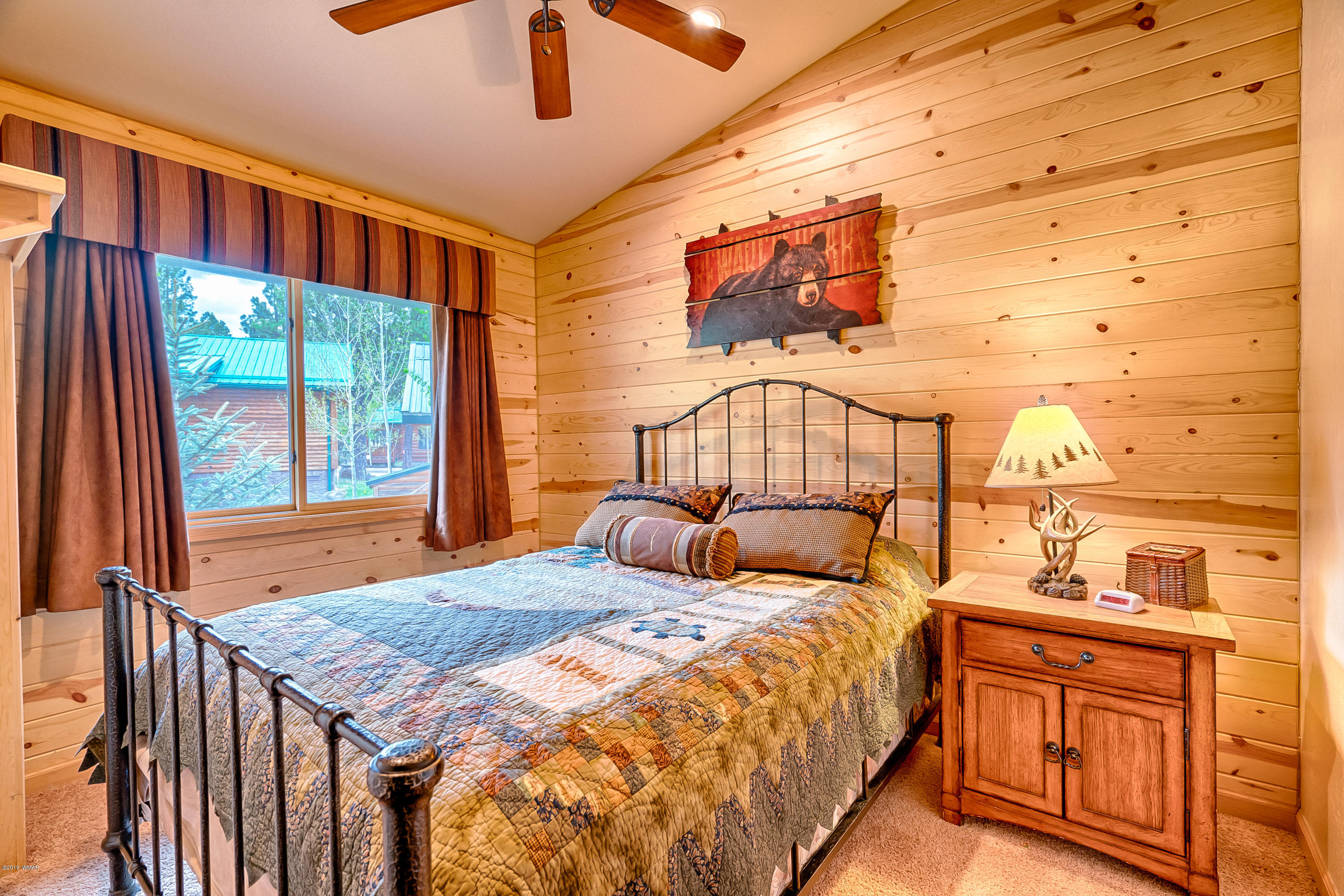 1120 Main, Unit 108 Greer, AZ 85927 - Photo 10 of 35 a bedroom with a bed and a window