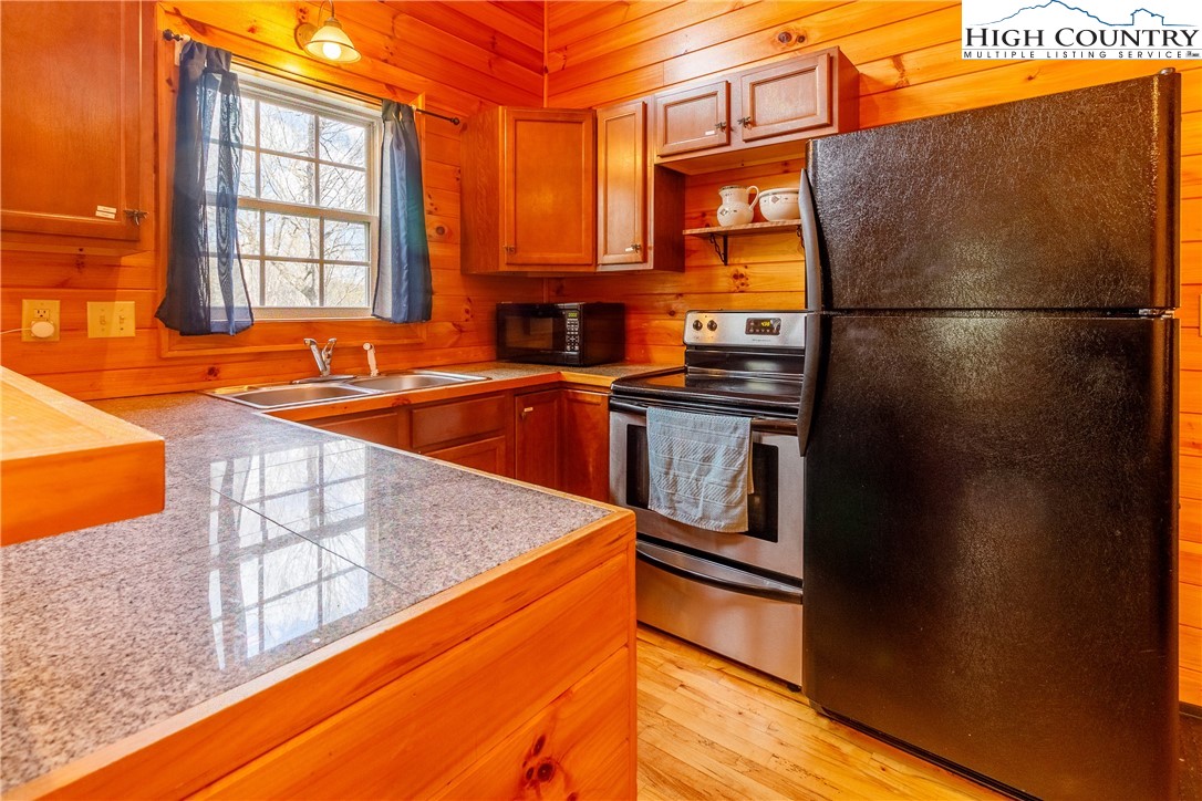 185 Marc Street Boone, NC 28607 - Photo 8 of 30 a kitchen that has a refrigerator and a sink