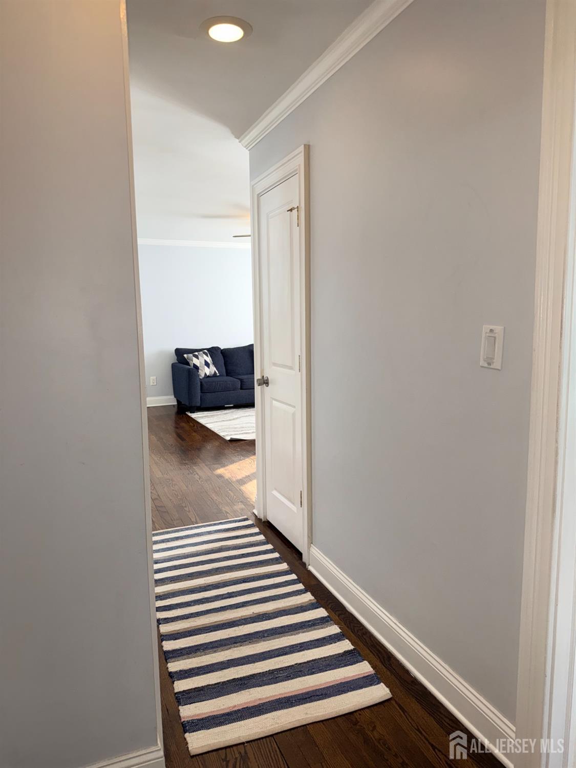 27 Rector Avenue Woodbridge, NJ 07095 - Photo 12 of 29 a view of a hallway with wooden floor and a bathroom