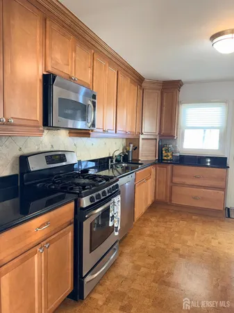 a kitchen with a refrigerator and cabinets