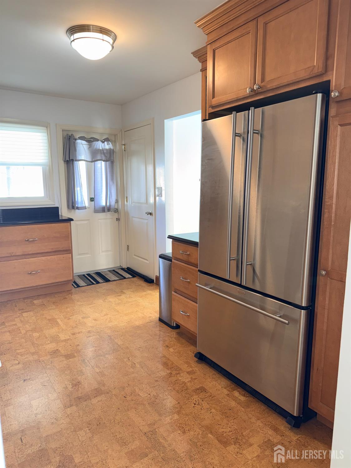 27 Rector Avenue Woodbridge, NJ 07095 - Photo 6 of 29 a kitchen with a refrigerator and cabinets