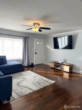 a living room with furniture and a chandelier