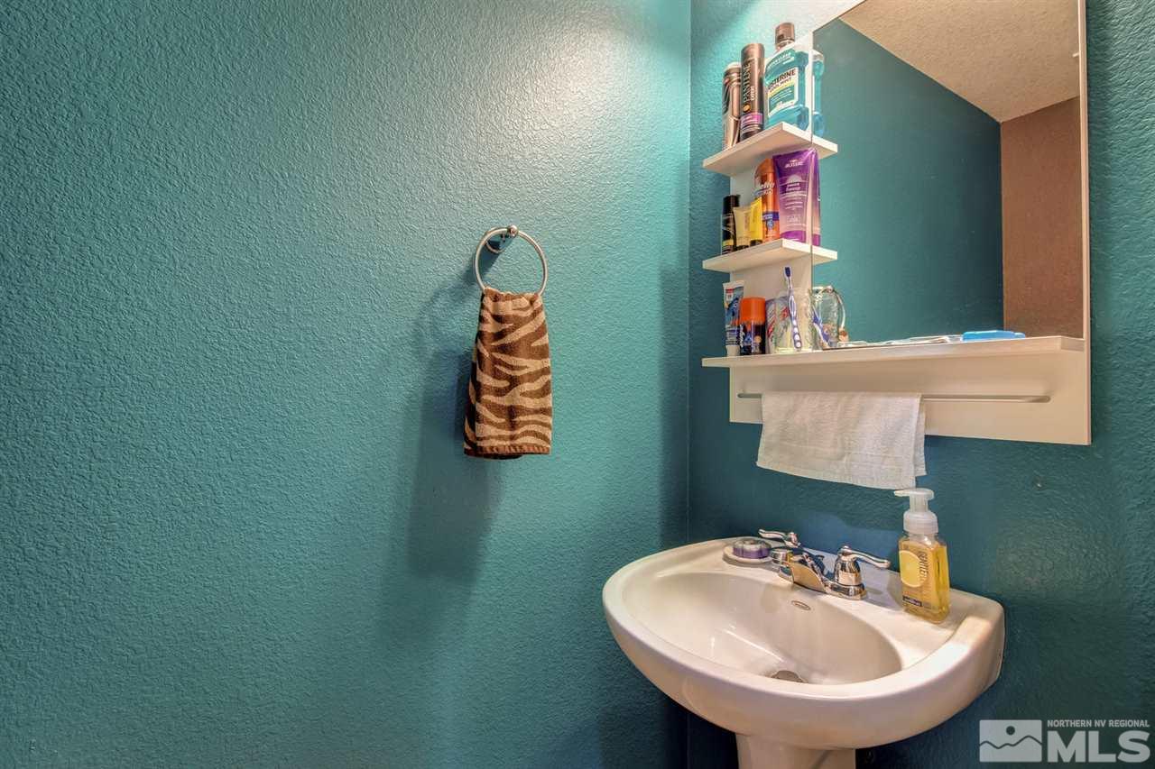 11033 Lamour Lane Reno, NV 89521 - Photo 23 of 25 a bathroom with a sink and a mirror