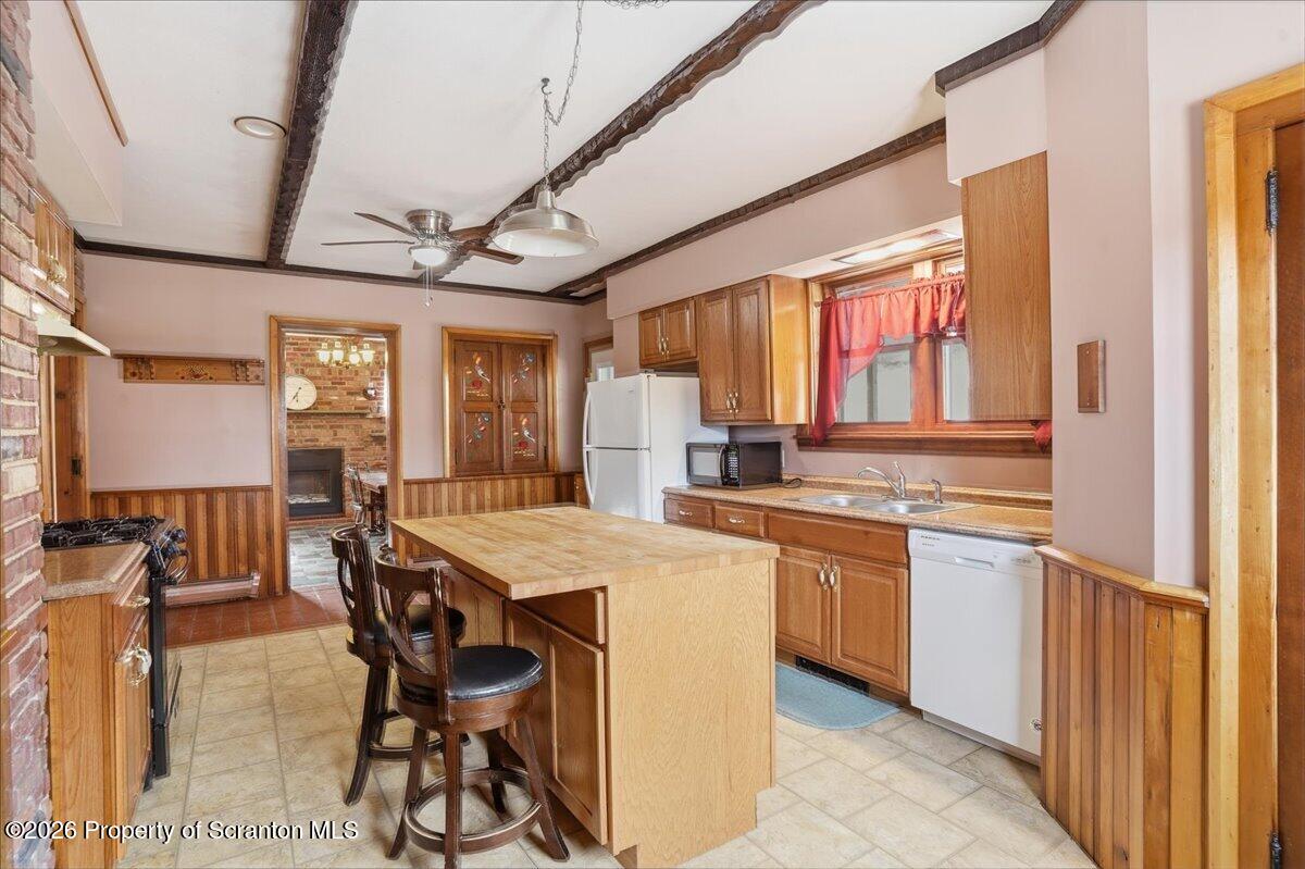 795 Wescott Road New Milford, PA 18834 - Photo 31 of 81 a kitchen with stainless steel appliances granite countertop a stove a refrigerator a dining table and chairs with wooden floor