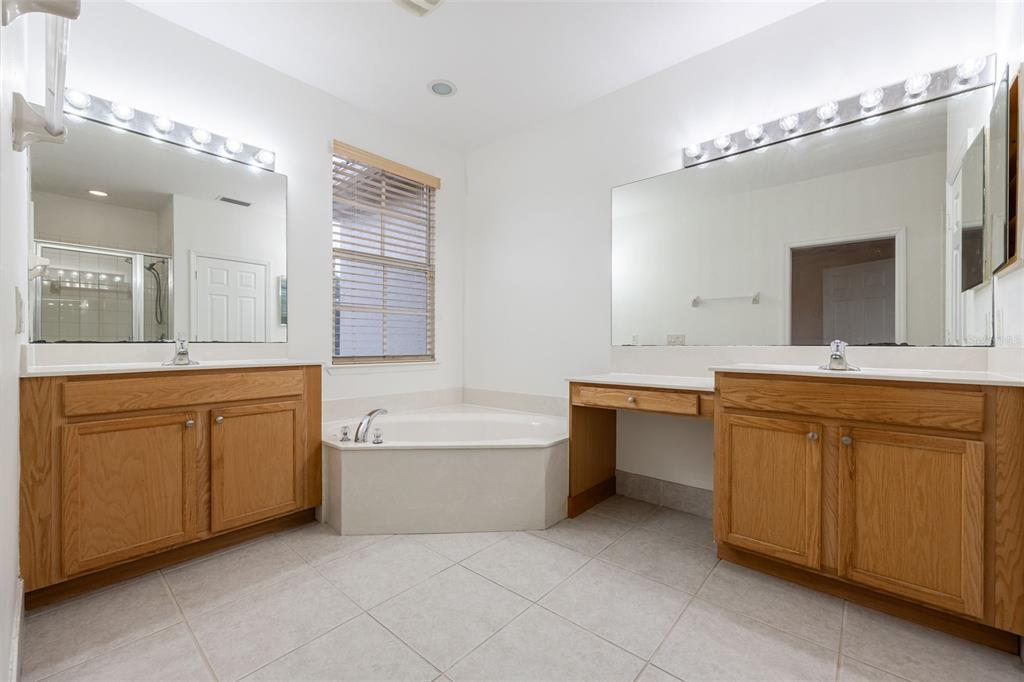 3956 Cherrybrook Loop Fort Myers, FL 33966 - Photo 21 of 44 a large bathroom with a double vanity sink a large mirror and a bathtub